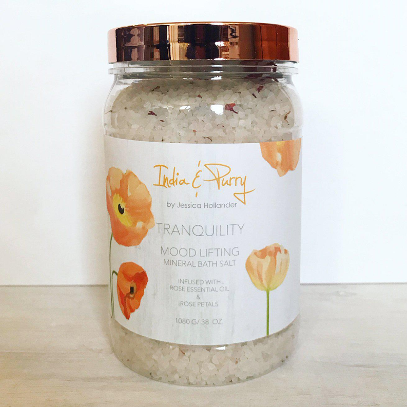 Rose bath salts in a clear glass jar with copper lid and pale granules