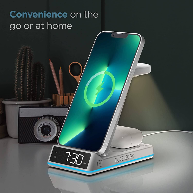 White charging stand with tilted phone dock, green charge icon, alarm clock display, blue base