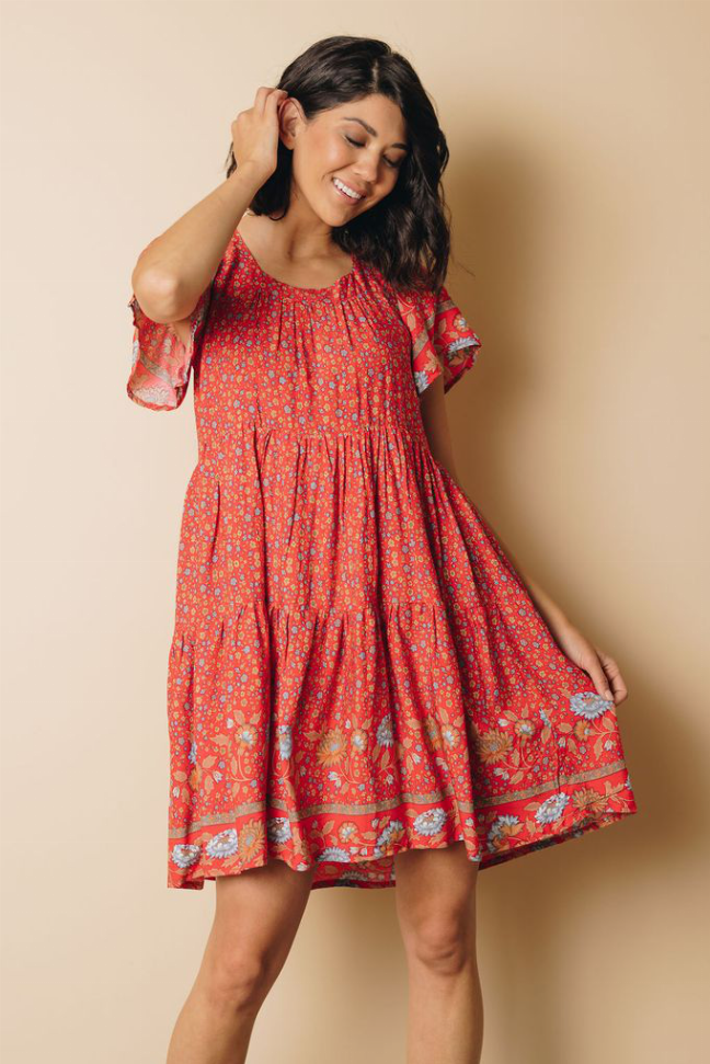 Red floral babydoll dress with smocked bodice and tiered mid-thigh skirt
