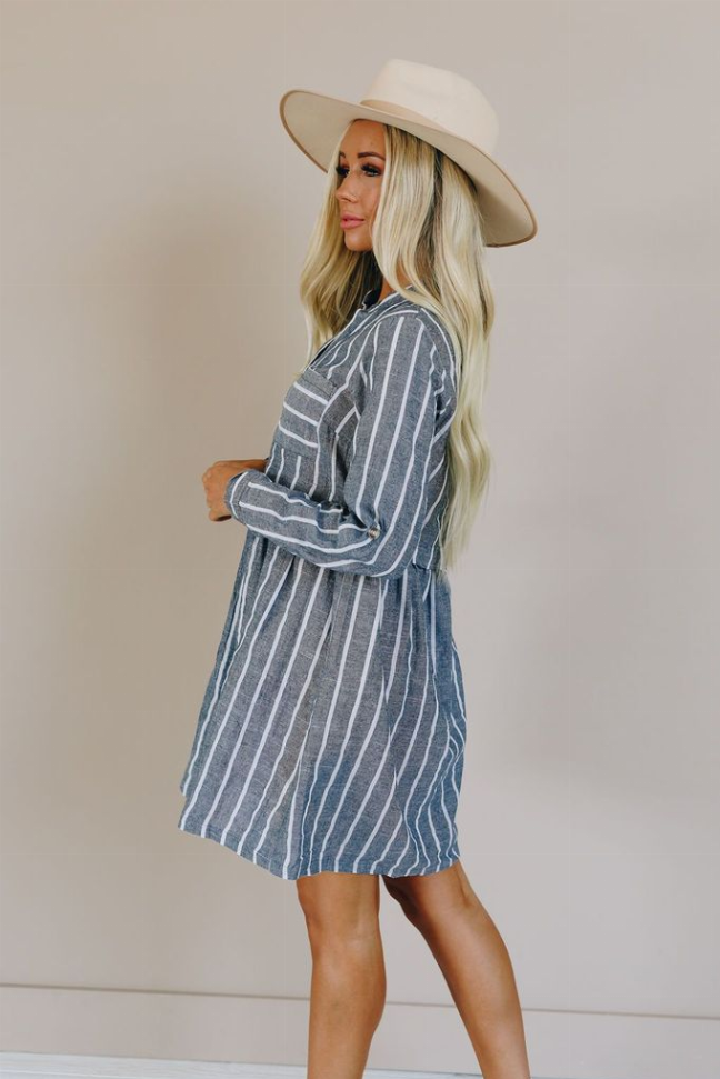 Blue and white striped button-front dress with long sleeves and pleated skirt