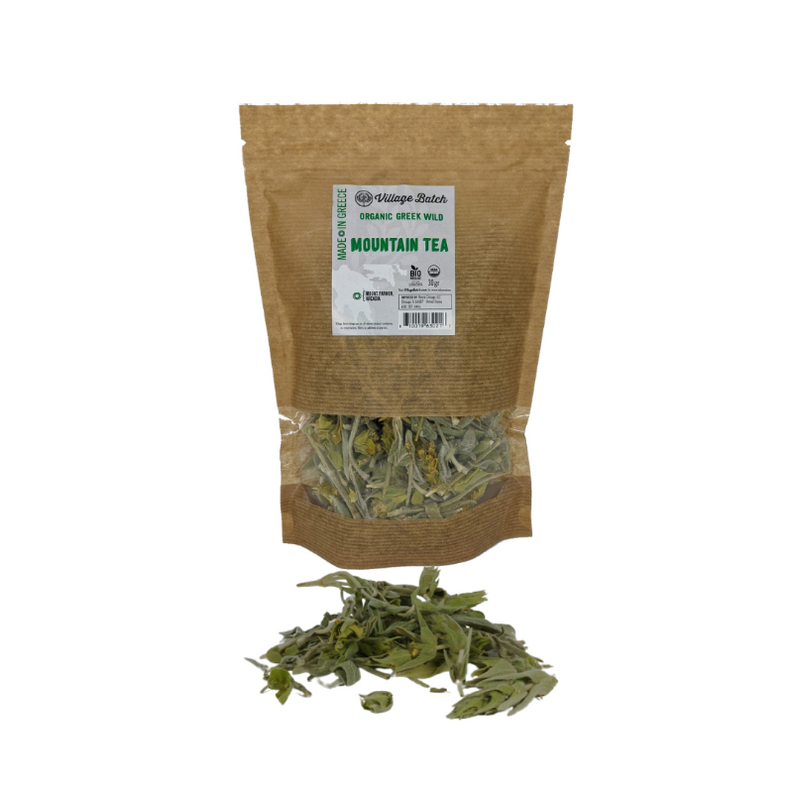Organic green mountain tea pouch standing with label and loose dried leaf tea