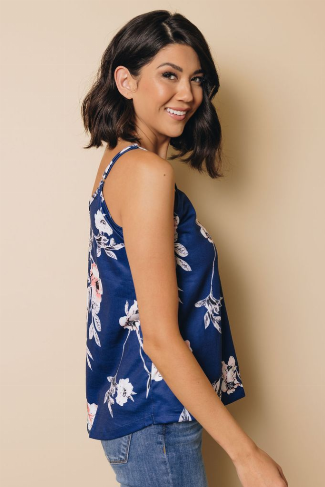 Blue floral tank top in side view with thin straps and V-neckline
