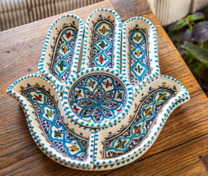 Ceramic hand-shaped dipping bowl with blue, teal, and colorful tile-style pattern