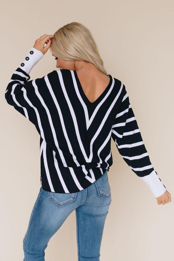Black and white striped V-neck knit sweater with long sleeves, back view