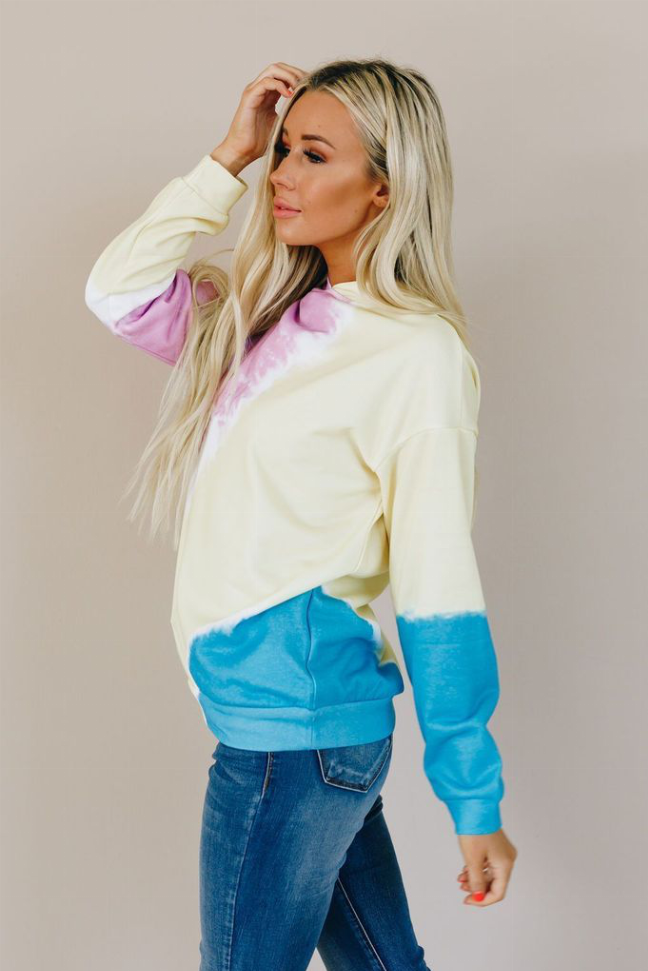 Colorblock tie-dye hoodie, side view with cream body and blue lower panel