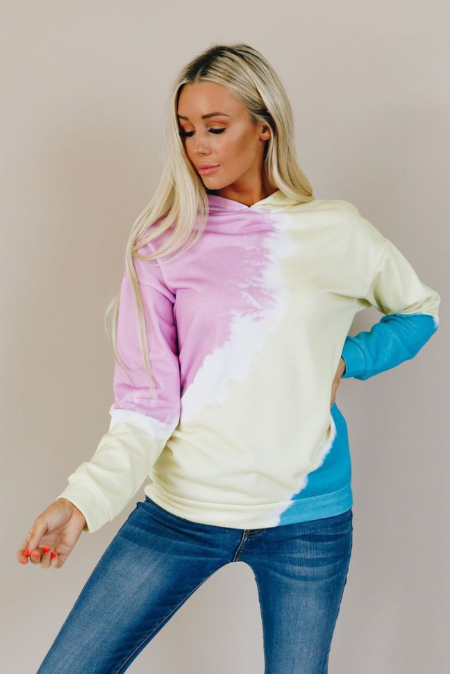 Colorblock tie-dye hoodie shown from front with pink chest panel, cream body, blue cuff