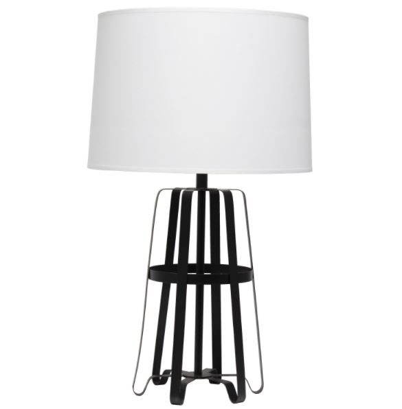 Table lamp with white drum shade and dark metal lantern-style cage base