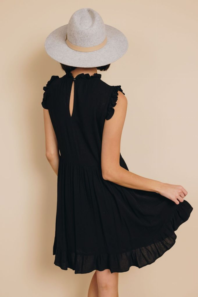 Black sleeveless ruffle dress with keyhole back and tiered skirt hem