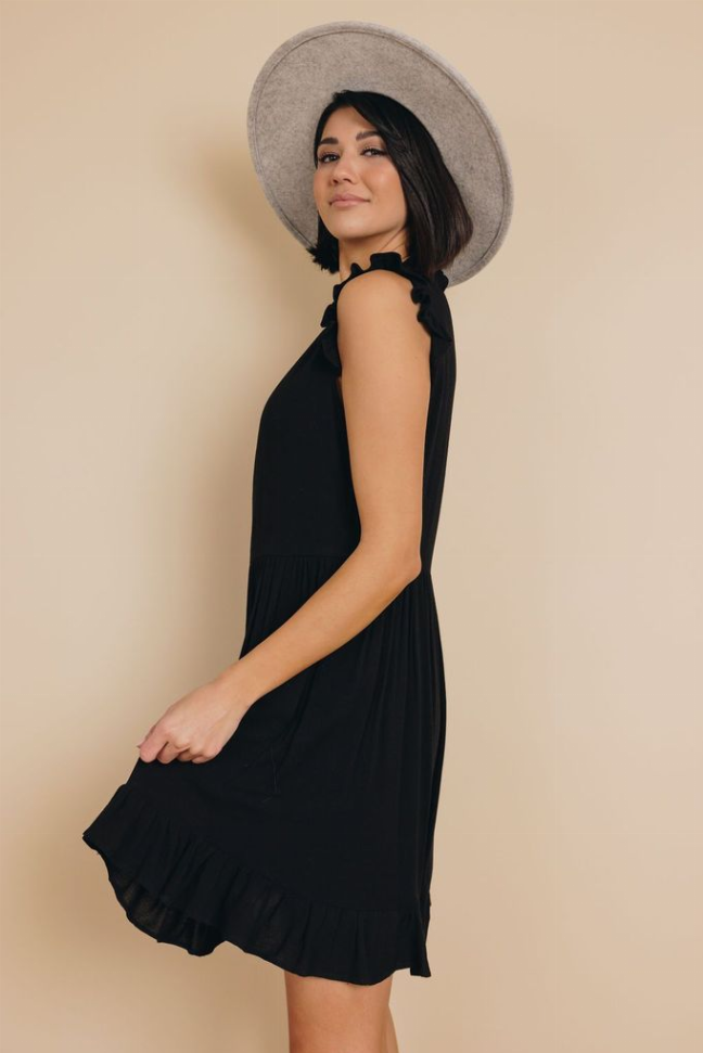 Black sleeveless ruffle dress with high neckline and gathered tiered hem