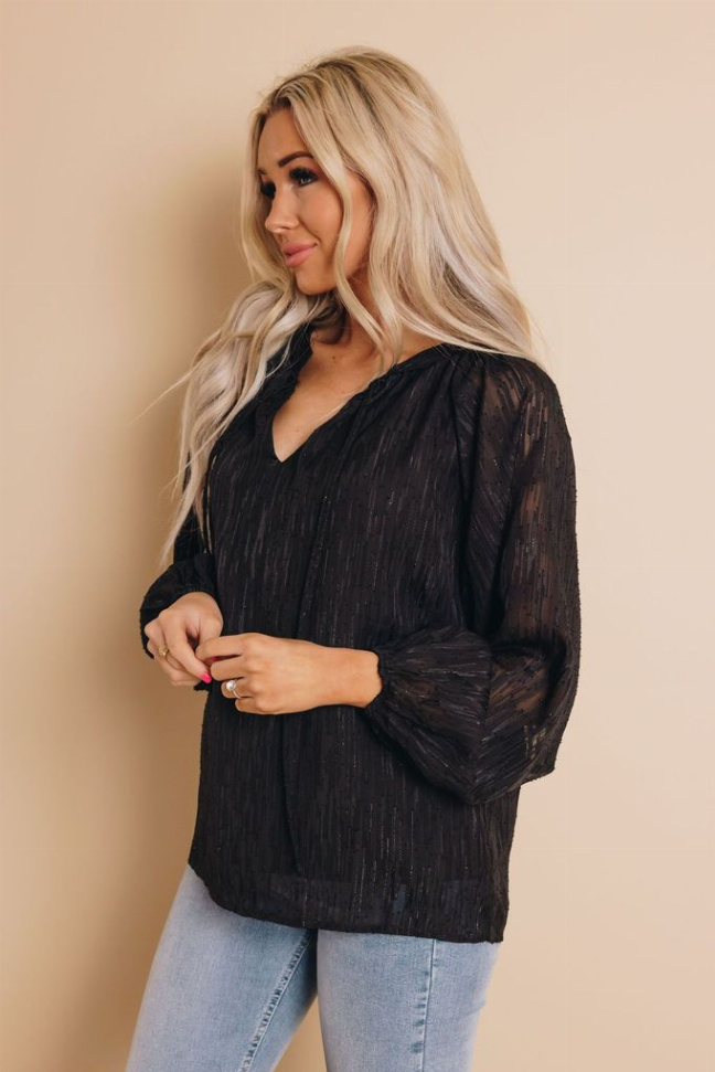 Black V-neck long-sleeve blouse top with textured fabric, side view