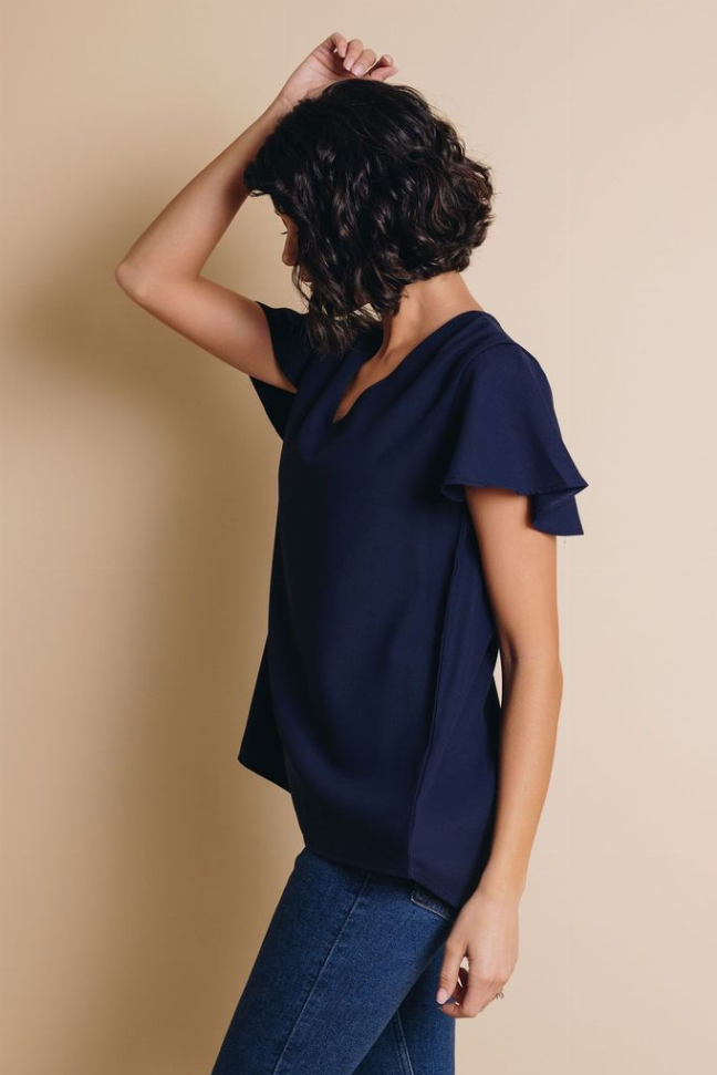Navy V-neck short-sleeve top, side view with flutter sleeve