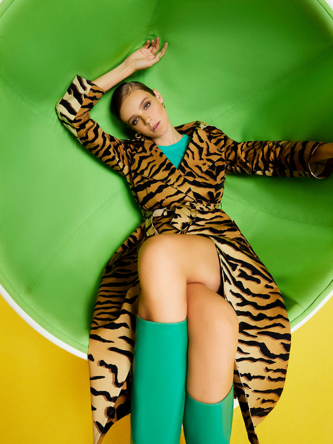 Tiger-print trench coat with belted waist and long sleeves, open neckline detail.