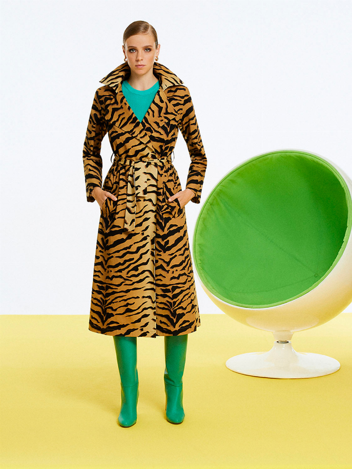 Tiger-print trench coat with belted waist, long sleeves, open collar, front view.