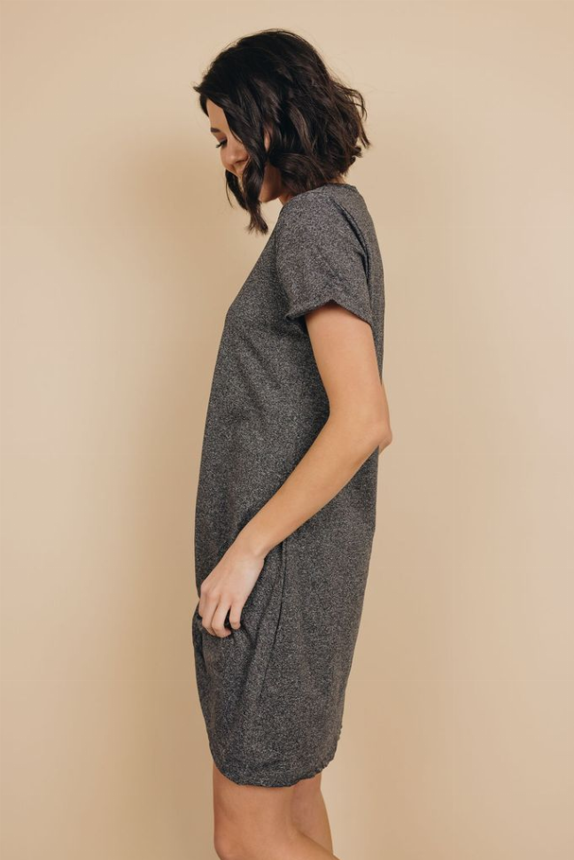 Side profile of dark gray heather knotted mini dress with short sleeves and V-neck