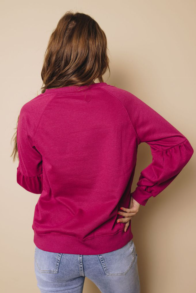 Magenta balloon-sleeve sweatshirt with crew neck, back view with gathered cuffs