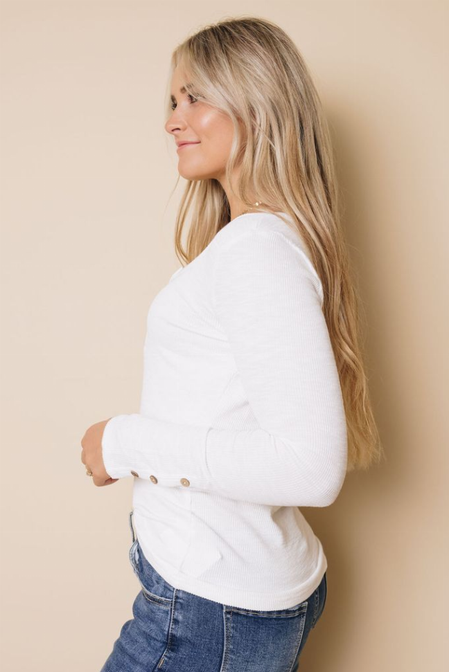 White long-sleeve henley top, side view with button placket and smooth long sleeves