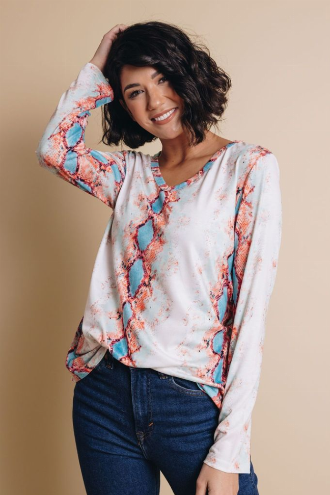 Snakeskin print V-neck long-sleeve top, white with coral and blue pattern, front view
