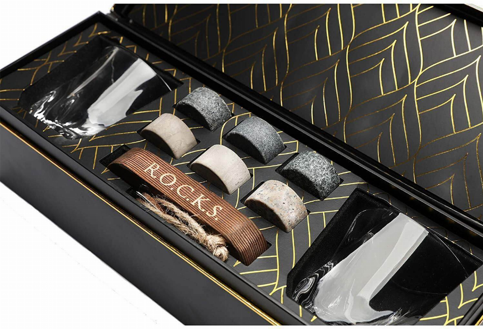 Whiskey chilling stones with two clear tumblers in a patterned gift box tray