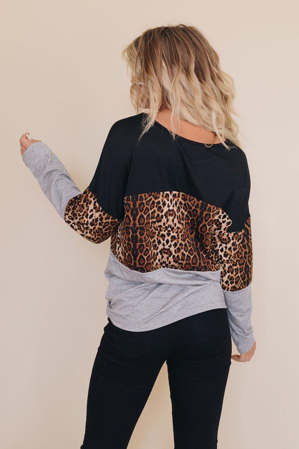 Back view long-sleeve top with leopard-print sleeves and black-and-gray color blocks