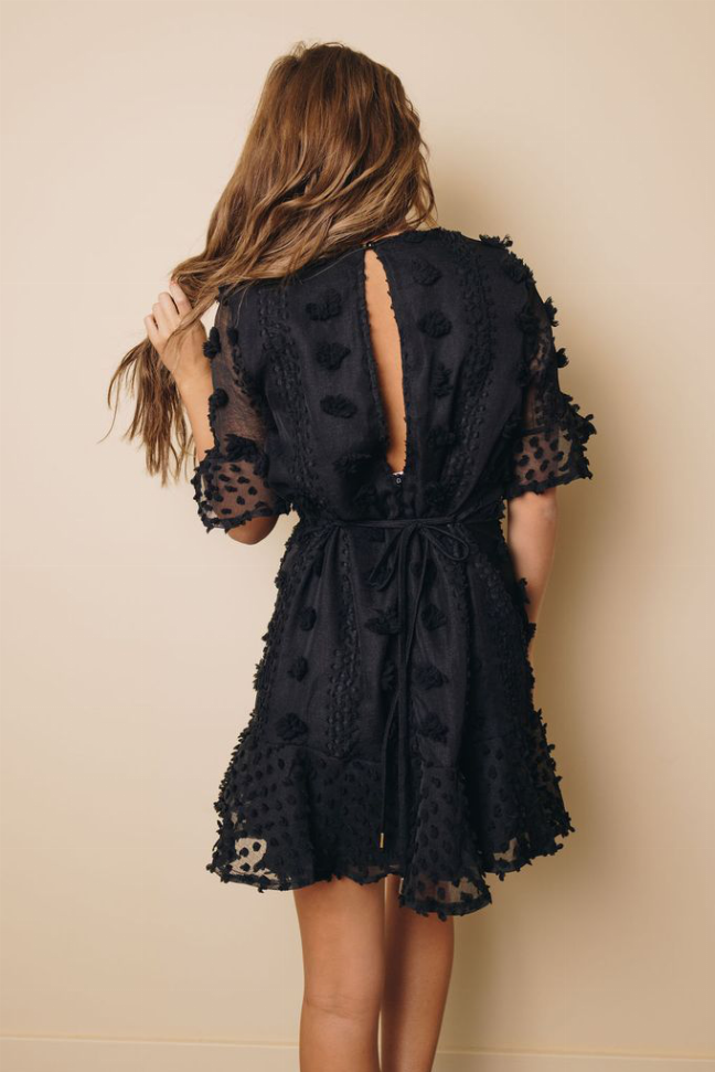 Black swiss dot mini dress with lace-trim back and tie waist, back view