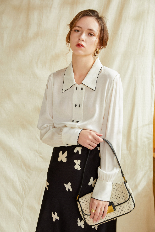 Black midi skirt with white butterfly print, gathered waist, full A-line shape