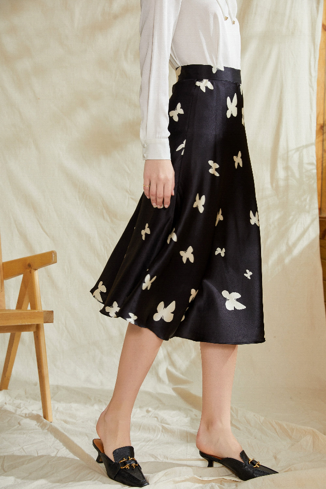 Black midi skirt with white butterfly print, gathered waist, A-line silhouette