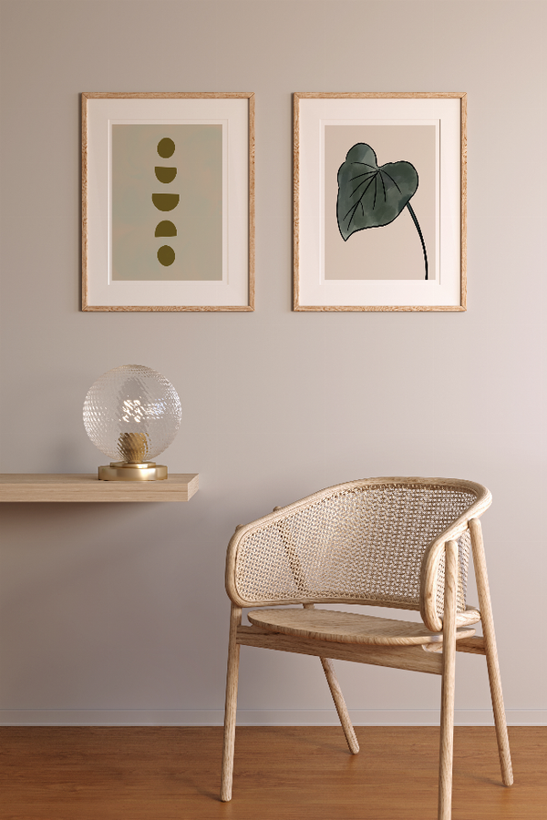 Set of two framed wall prints with stacked olive circles and a leaf-like icon