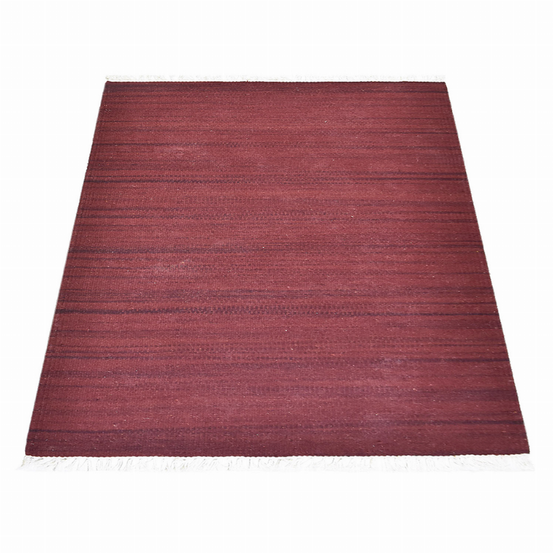 Solid burgundy handwoven wool kilim rug with flat striped texture and white fringe.