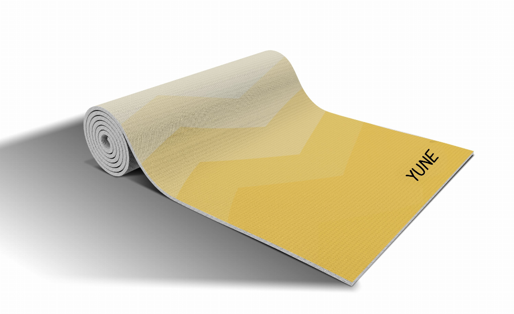 Yoga mat rolled and laid out with yellow chevron design and YUNE logo