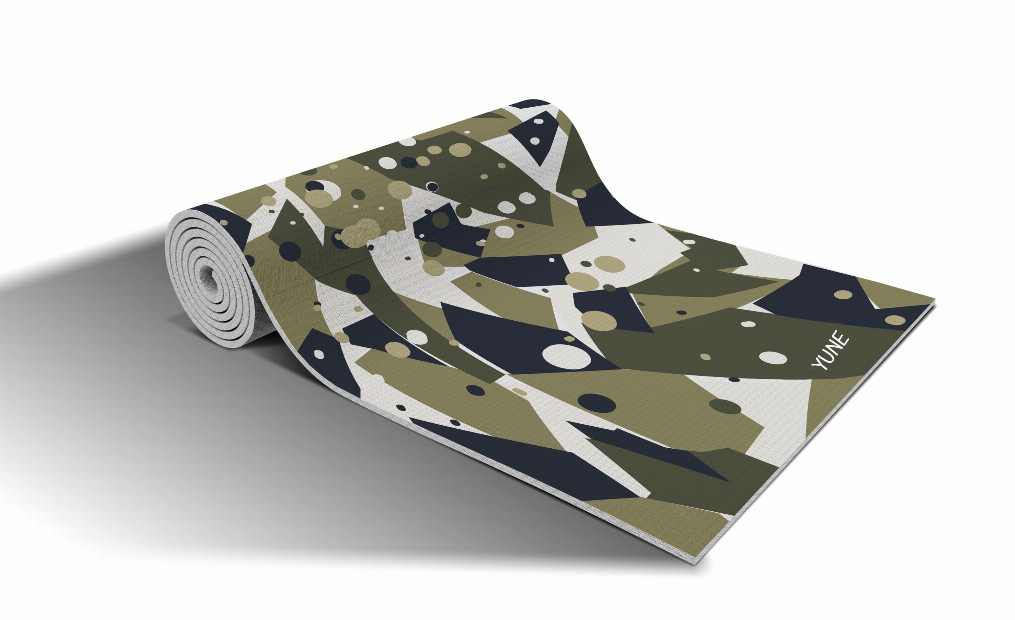Rolled yoga mat with granite camo pattern of geometric shapes; 'YONE' label