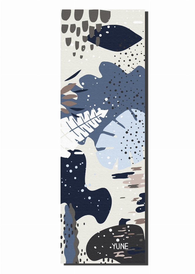 Yoga mat with abstract navy, beige, and tan animal-like pattern, vertical view