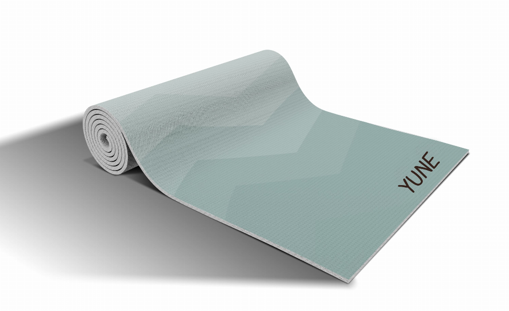 Rolled teal yoga mat with chevron zigzag texture and YUNE label on end