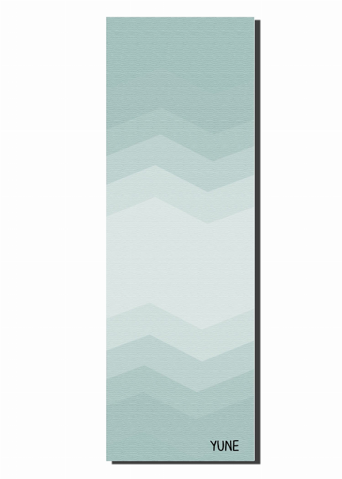 Teal yoga mat laid flat showing chevron zigzag pattern and YUNE logo at bottom