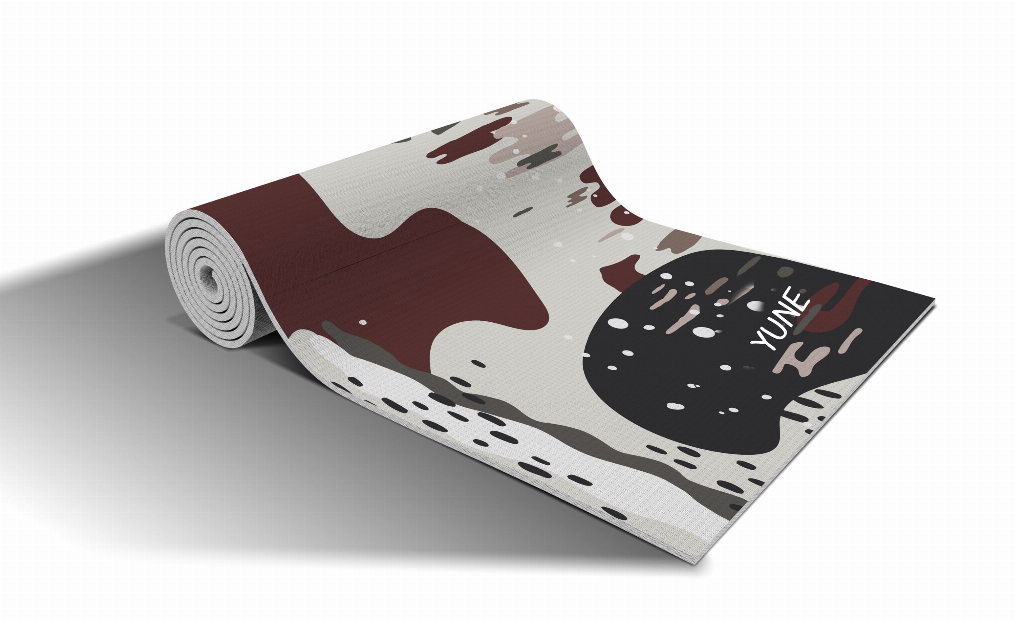 Yoga mat with abstract maroon, cream, and dark patterns, rolled for storage