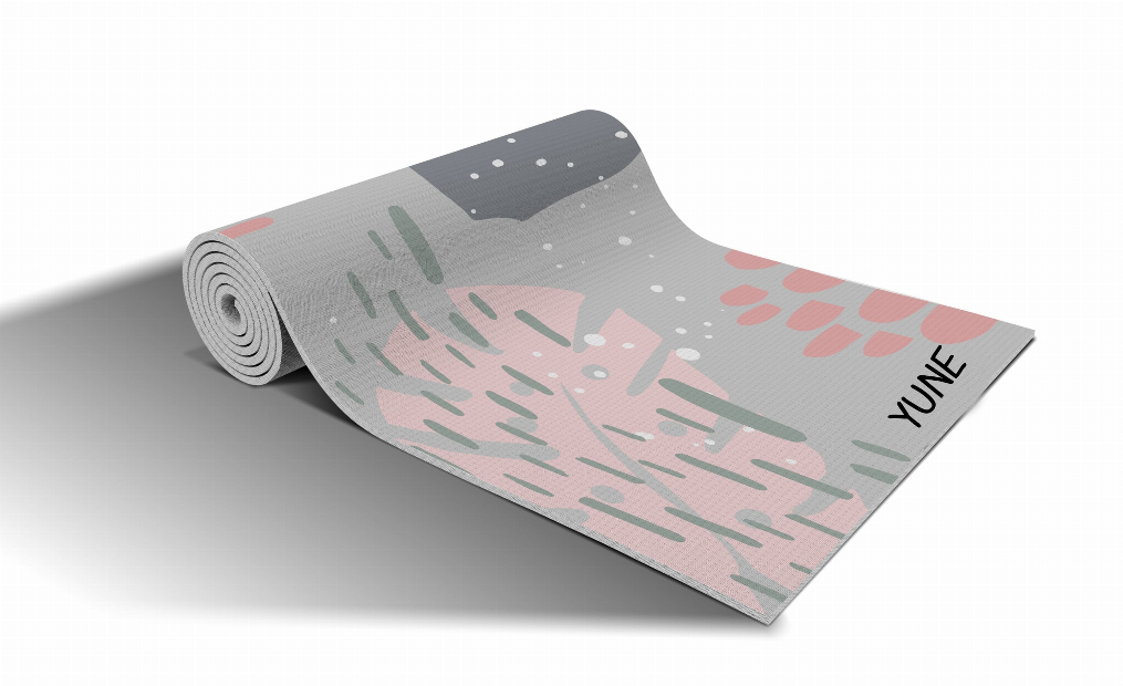 Gray yoga mat with pink and green cactus pattern, rolled up