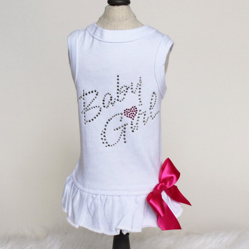 Sleeveless white dress with rhinestone 'Love', bright pink bow, and ruffled hem