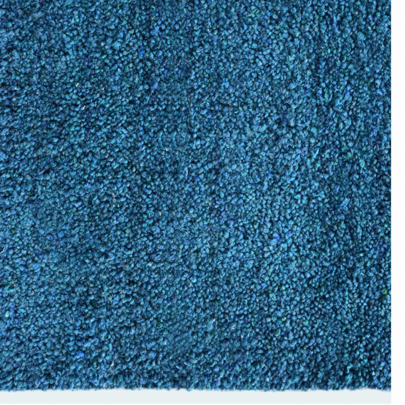Blue shag area rug, dense pile texture close-up