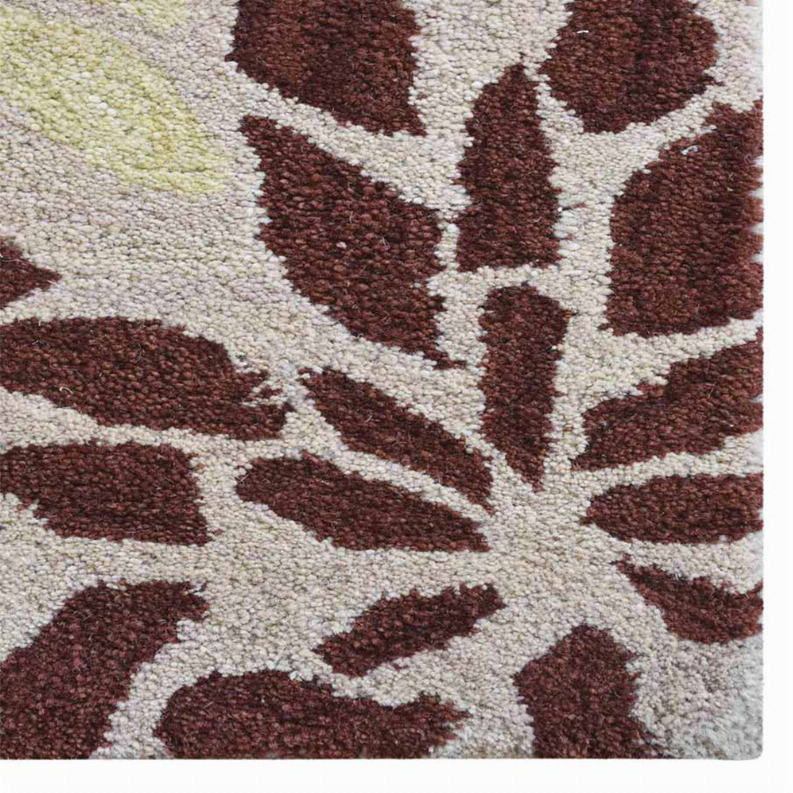 Hand-tufted shag area rug with burgundy geometric motifs on off-white background