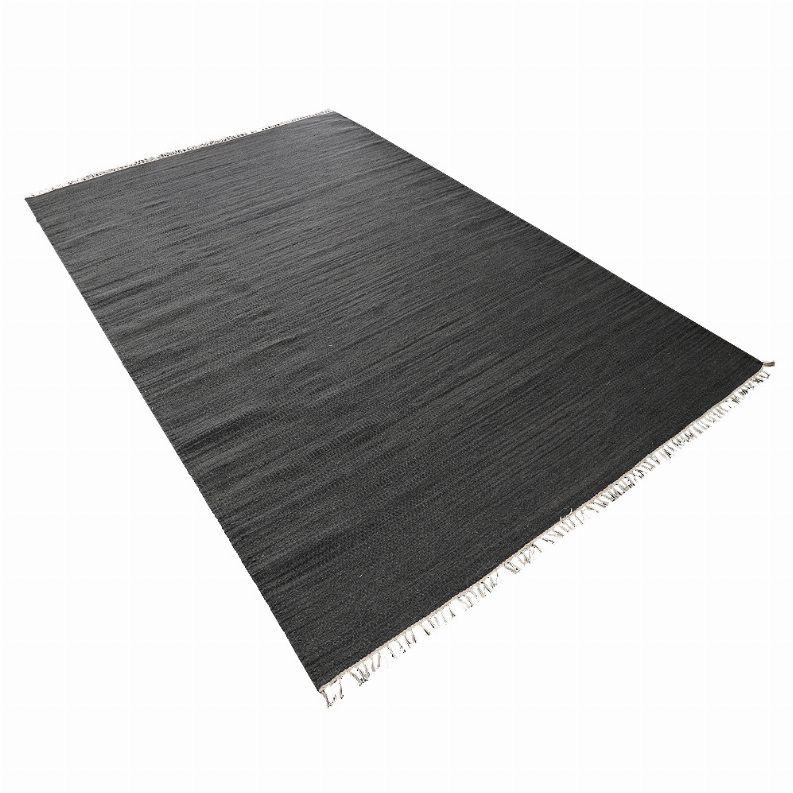 Dark gray wool flatweave kilim rug, angled view with fringe border