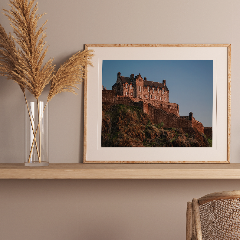Framed castle wall art with light wood frame and full fortress view.