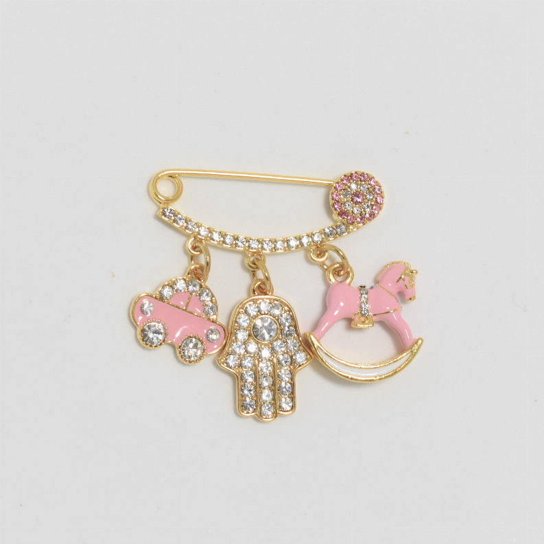 Gold-tone baby safety pin with pink horse, heart, and hand charms, rhinestone details