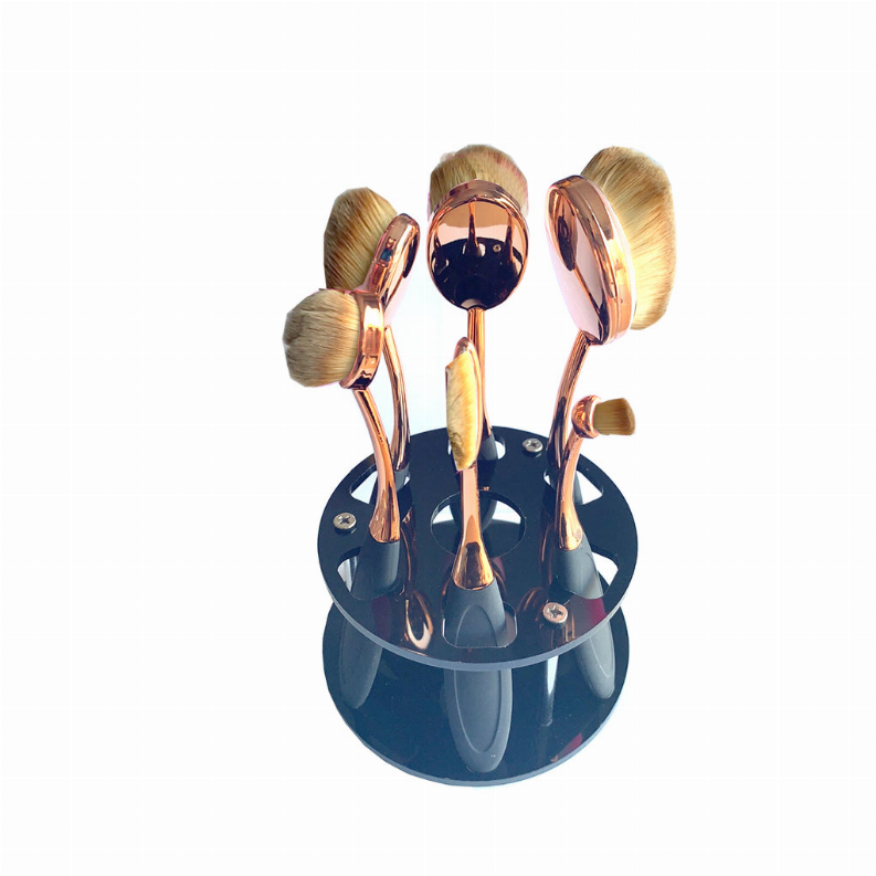 Beauty brush caddy with six oval brushes, copper stems and blue base