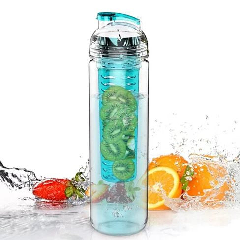Clear bottle with teal dome infuser holding green slices, with orange fruit splash.