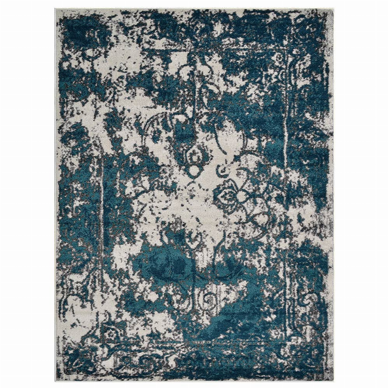 Abstract area rug with teal and blue ornate motifs on white center field
