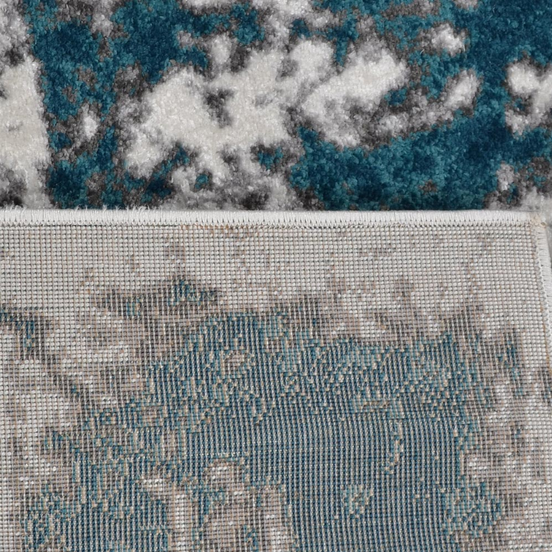 Abstract area rug close-up border with teal-blue details on white ground
