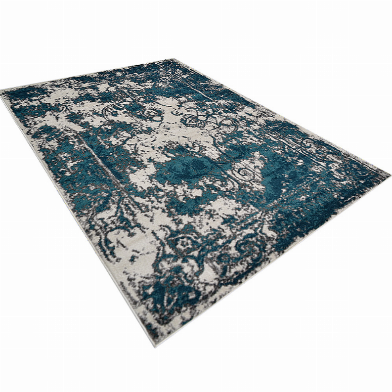 Abstract area rug in teal-blue and ivory with faded distressed medallion pattern