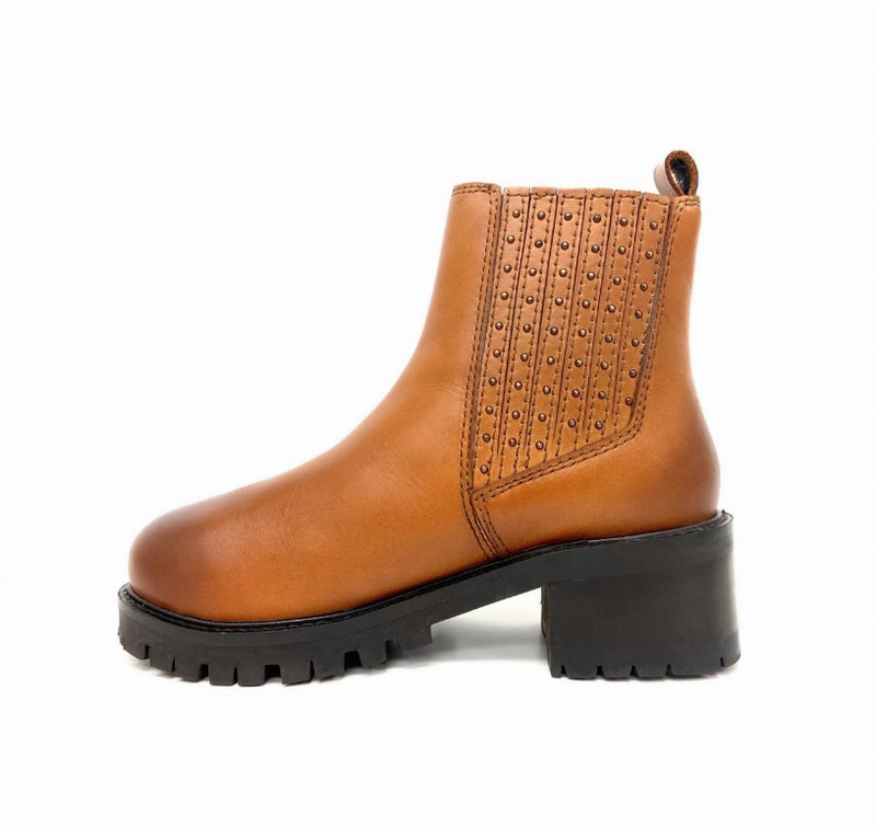 Tan Chelsea boot side view with studded elastic gore panel and chunky black platform
