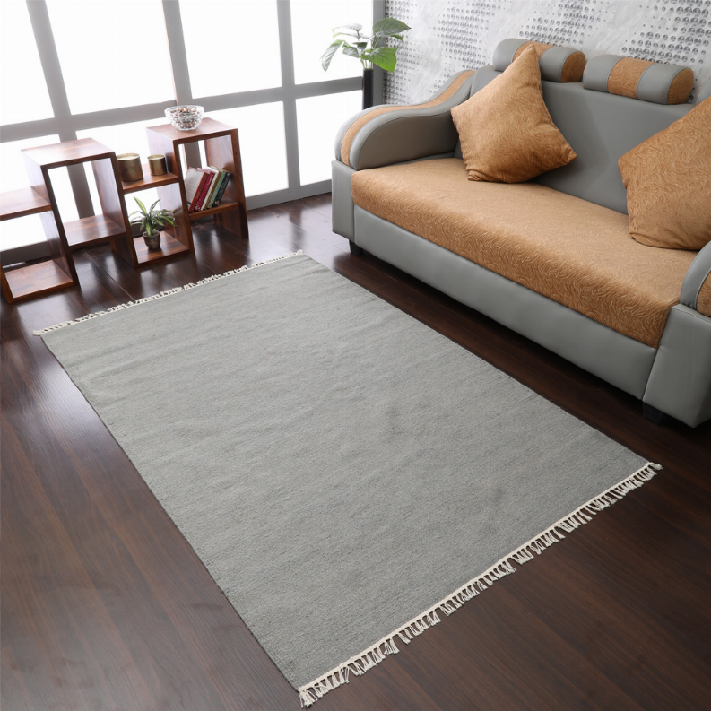 Gray solid flatweave wool area rug with cream fringe, centered straight-on view