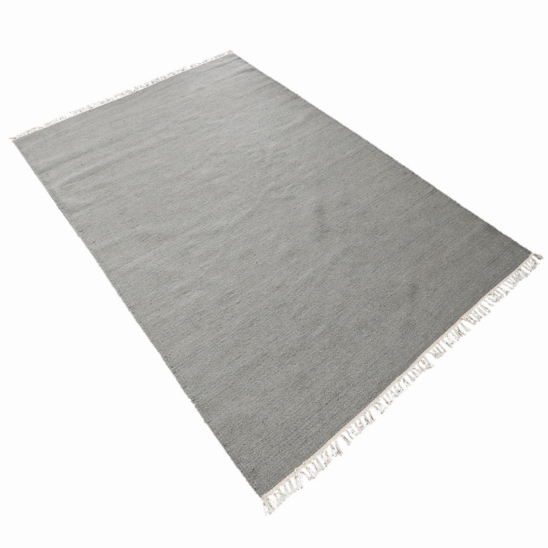 Solid gray flatweave wool area rug with cream tassel fringe edges.