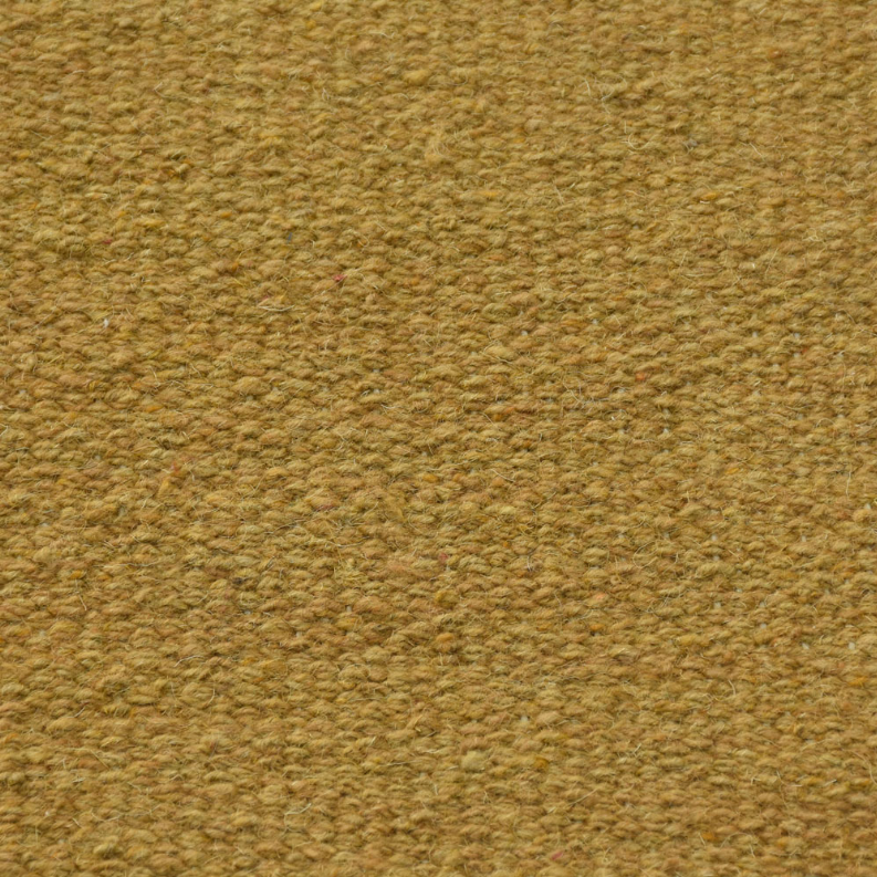 Solid mustard wool rug close-up, tight flat weave surface